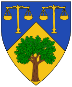 Device: Per chevron azure and Or, two standing balances Or and a tree proper