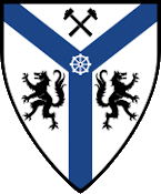 Device: Argent, on a pall azure between two hammers in saltire and two wolves rampant addorsed sable a wheel argent